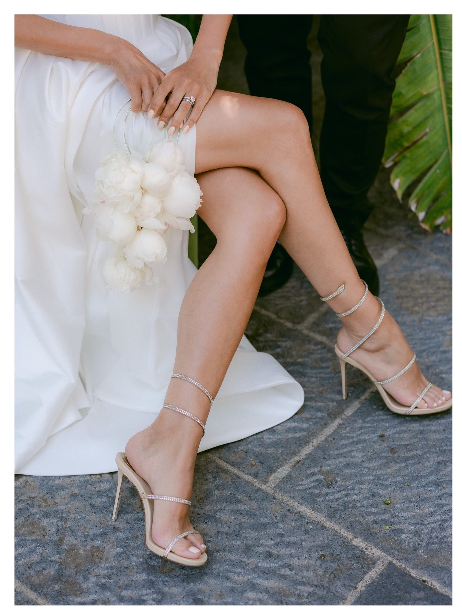 Detail of the bride's gown and bouquet