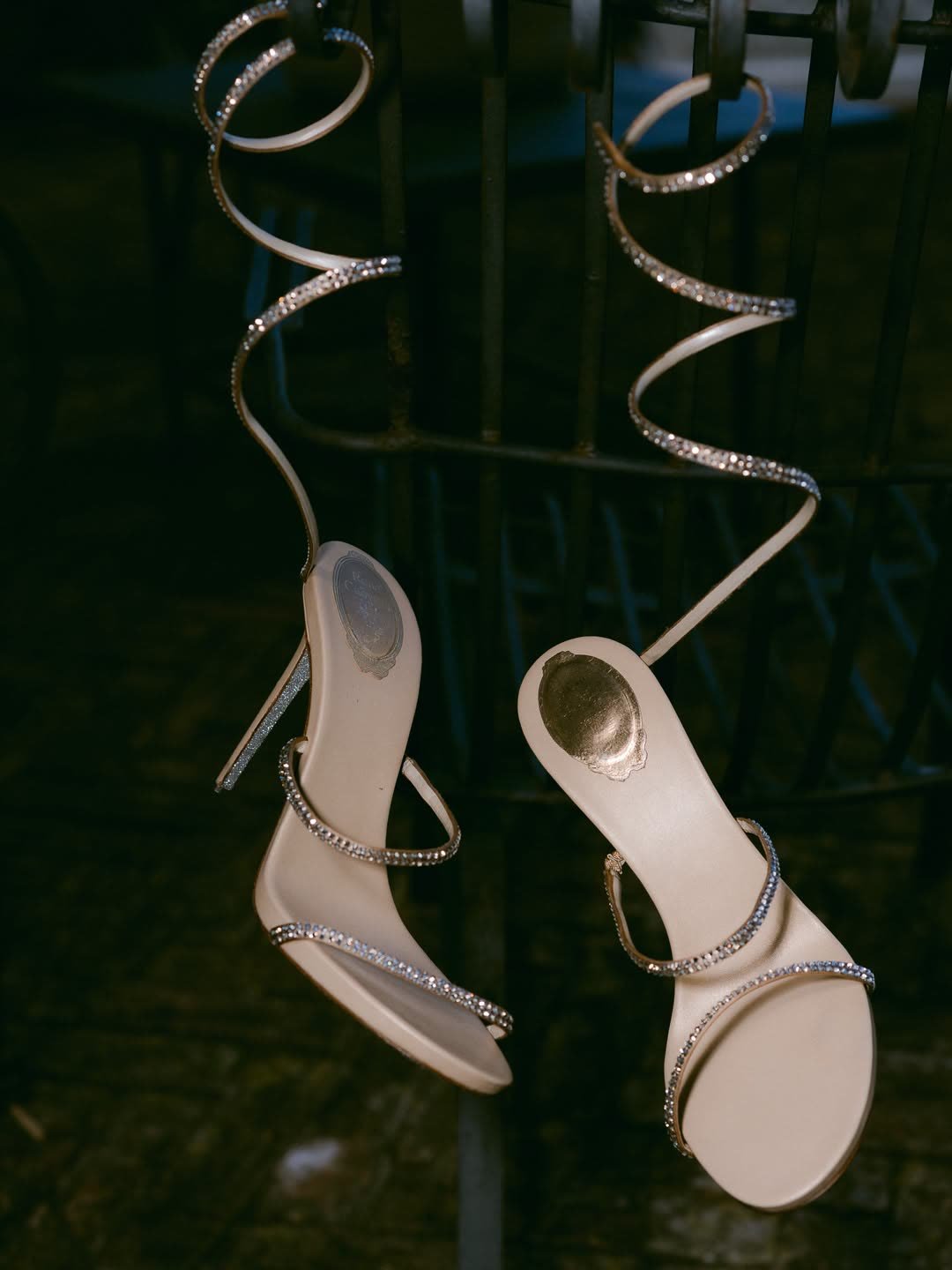 Bridal shoes hanging from an iron gate