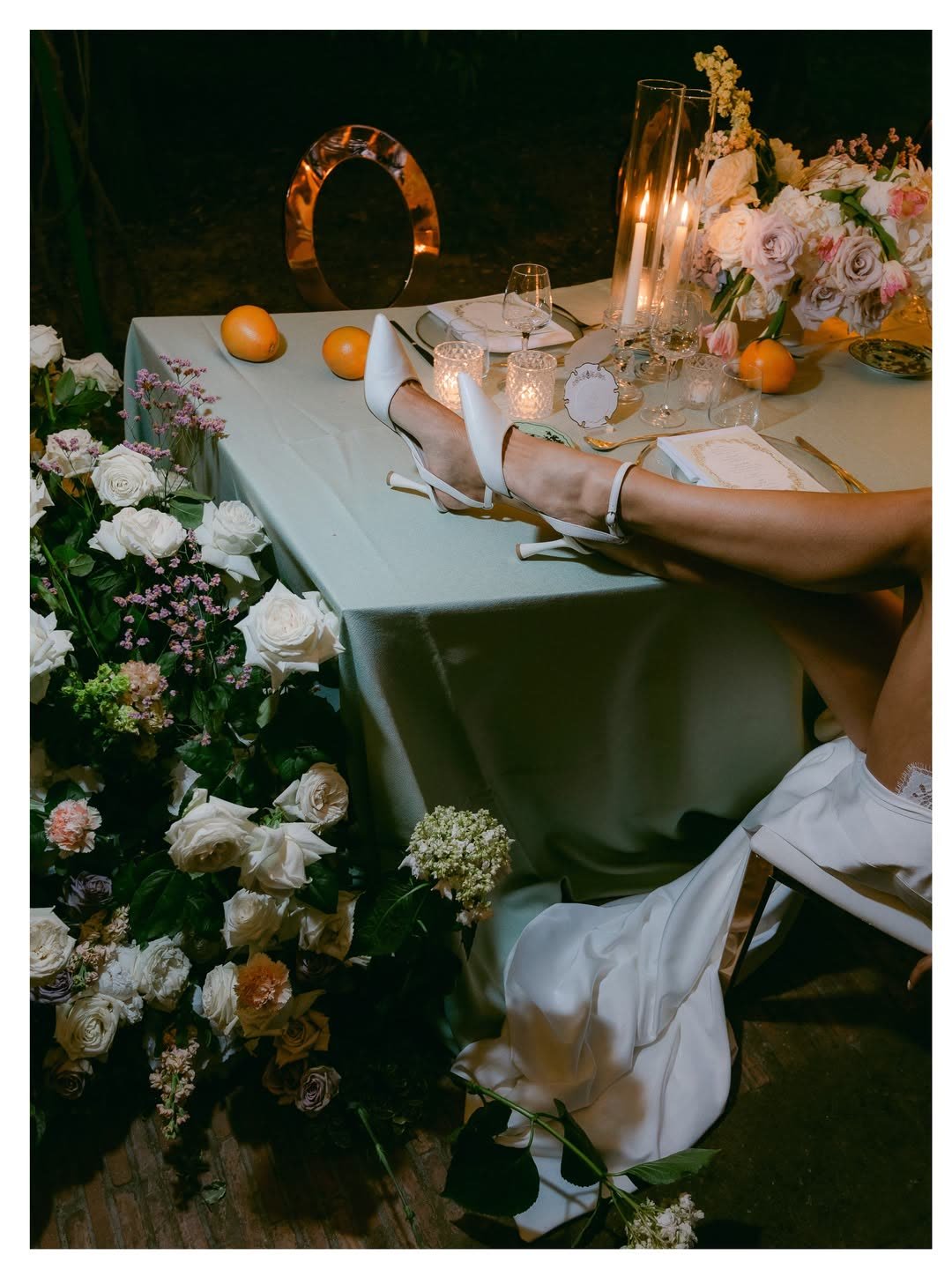 Reception table detail with oranges and candlelight