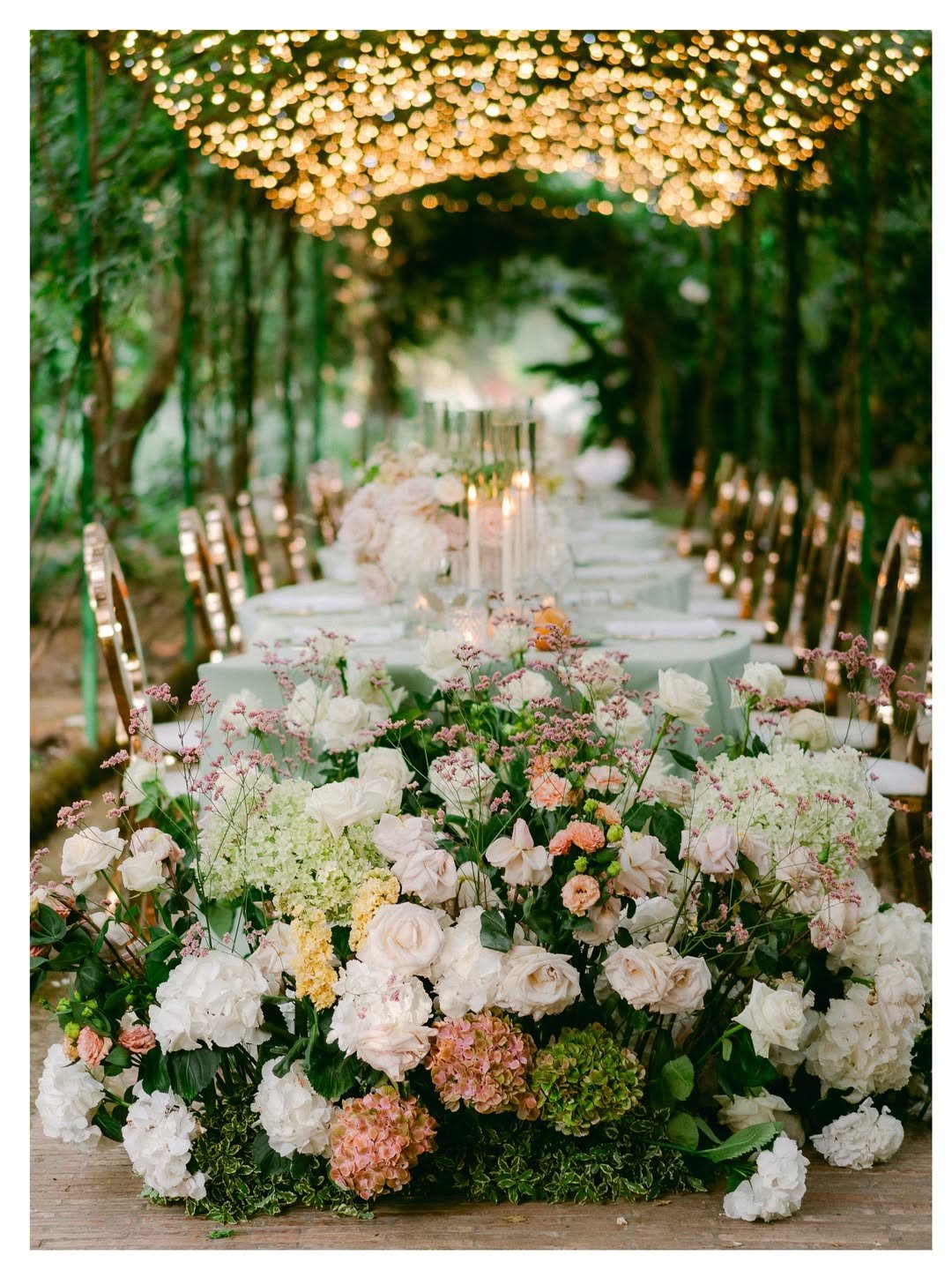 The reception table beneath a canopy of string lights