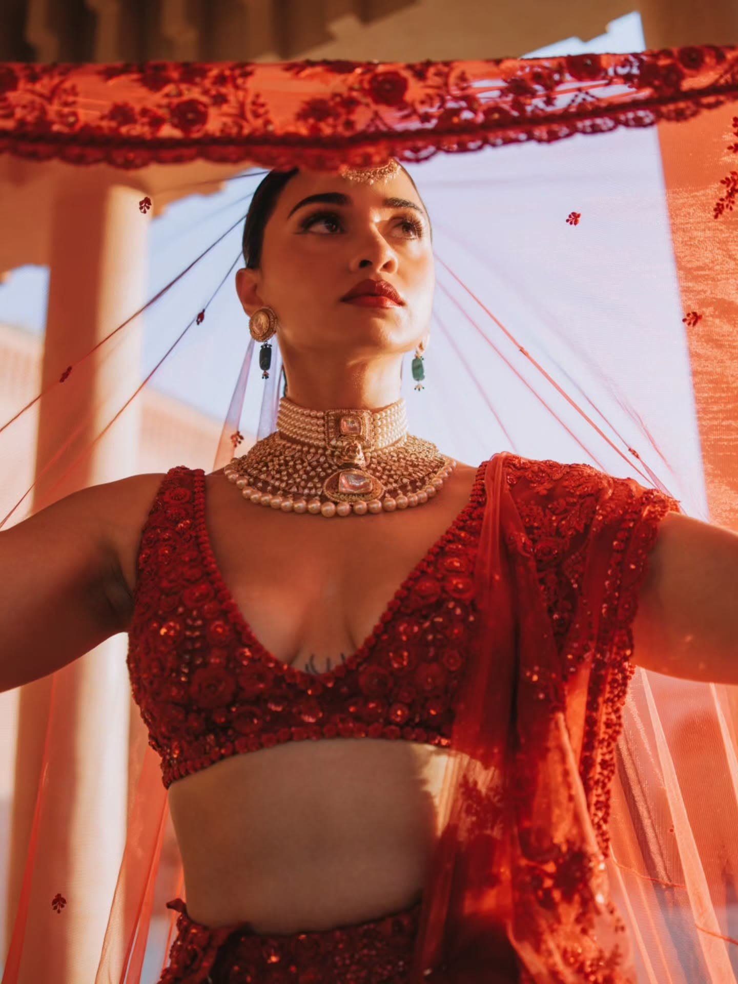 Henna in a red bridal lehenga beneath her veil, Marrakech