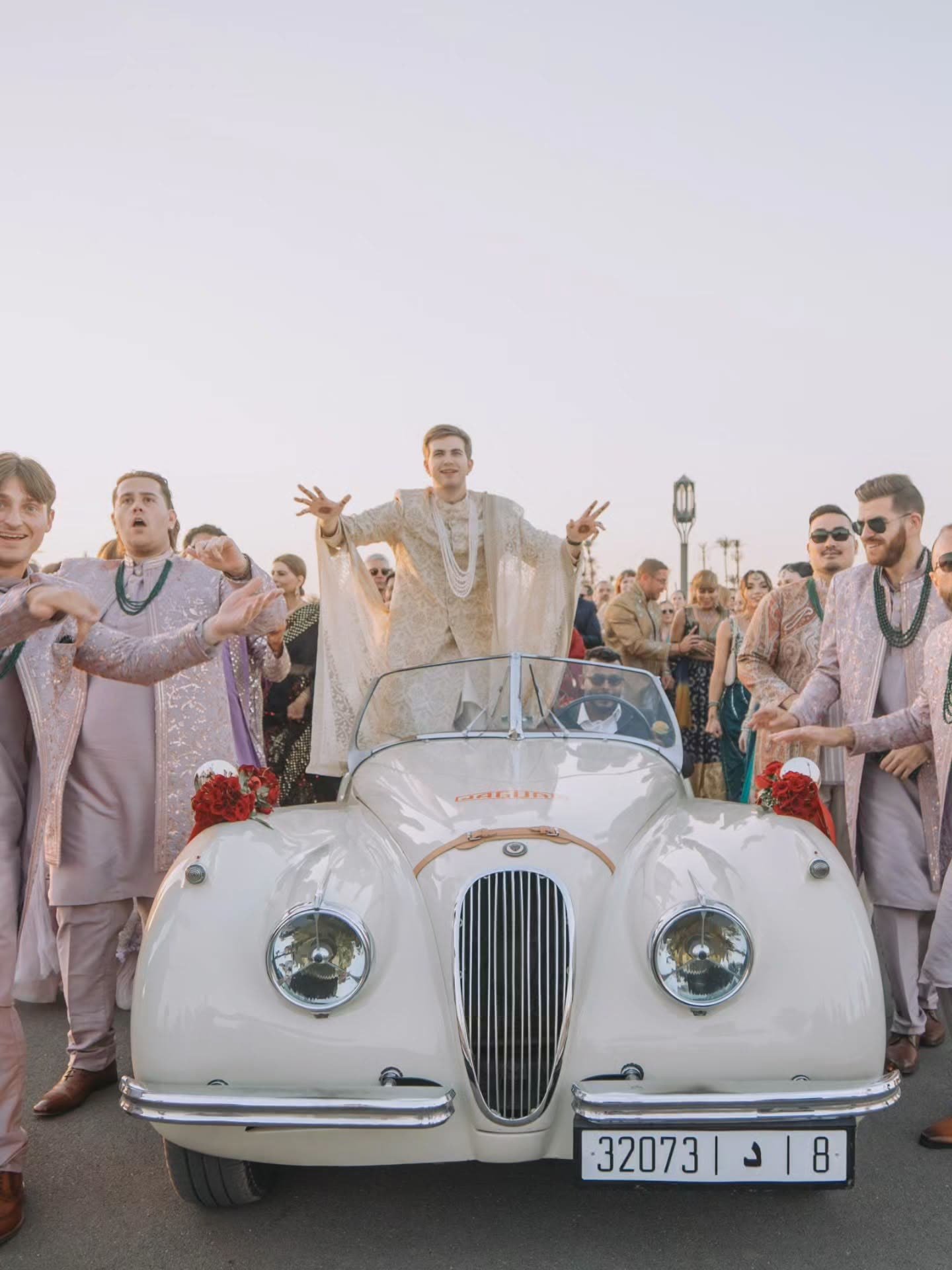The Baraat with a vintage roadster and dancing guests in Marrakech
