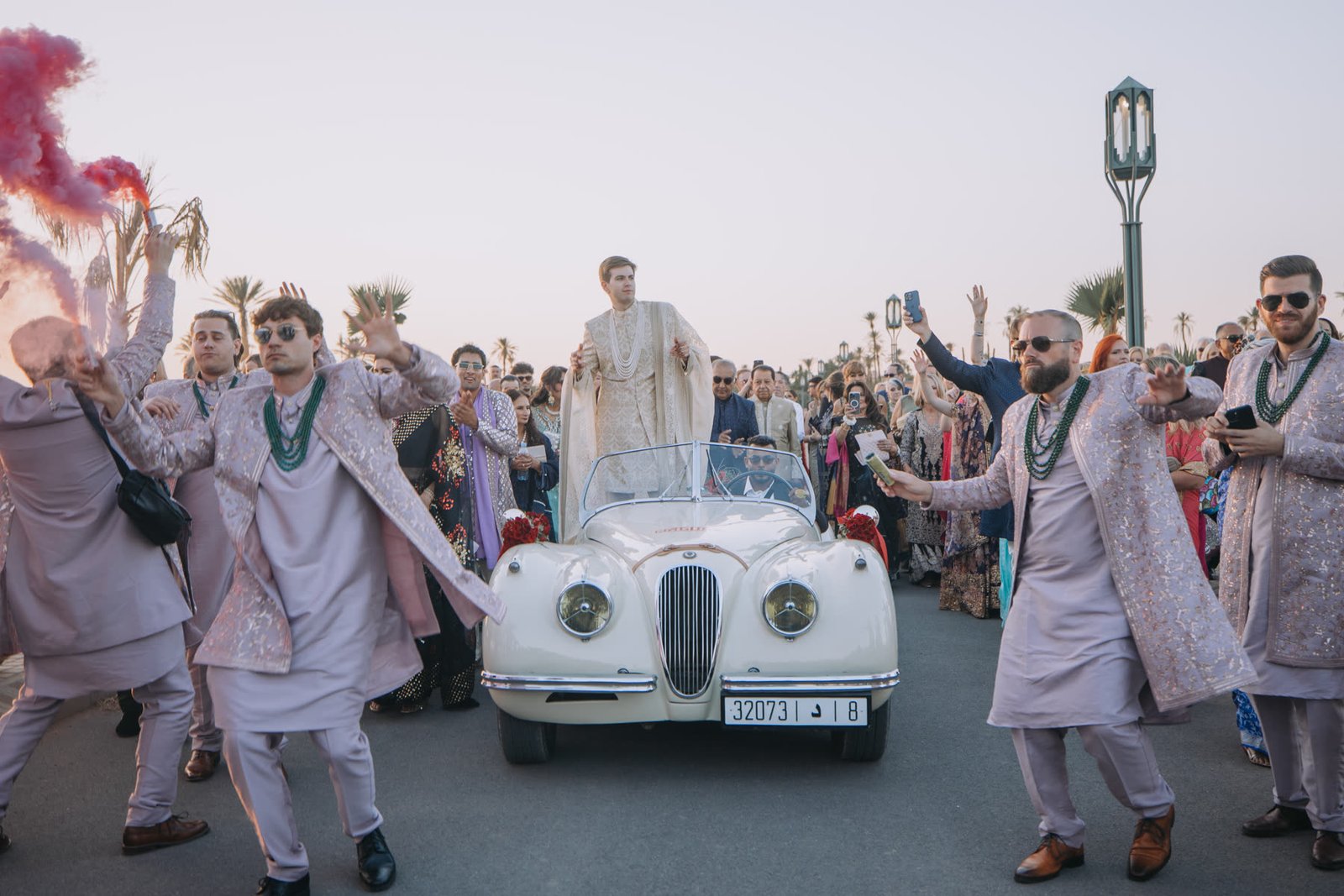 Guests dancing around the groom during the Baraat in Marrakech