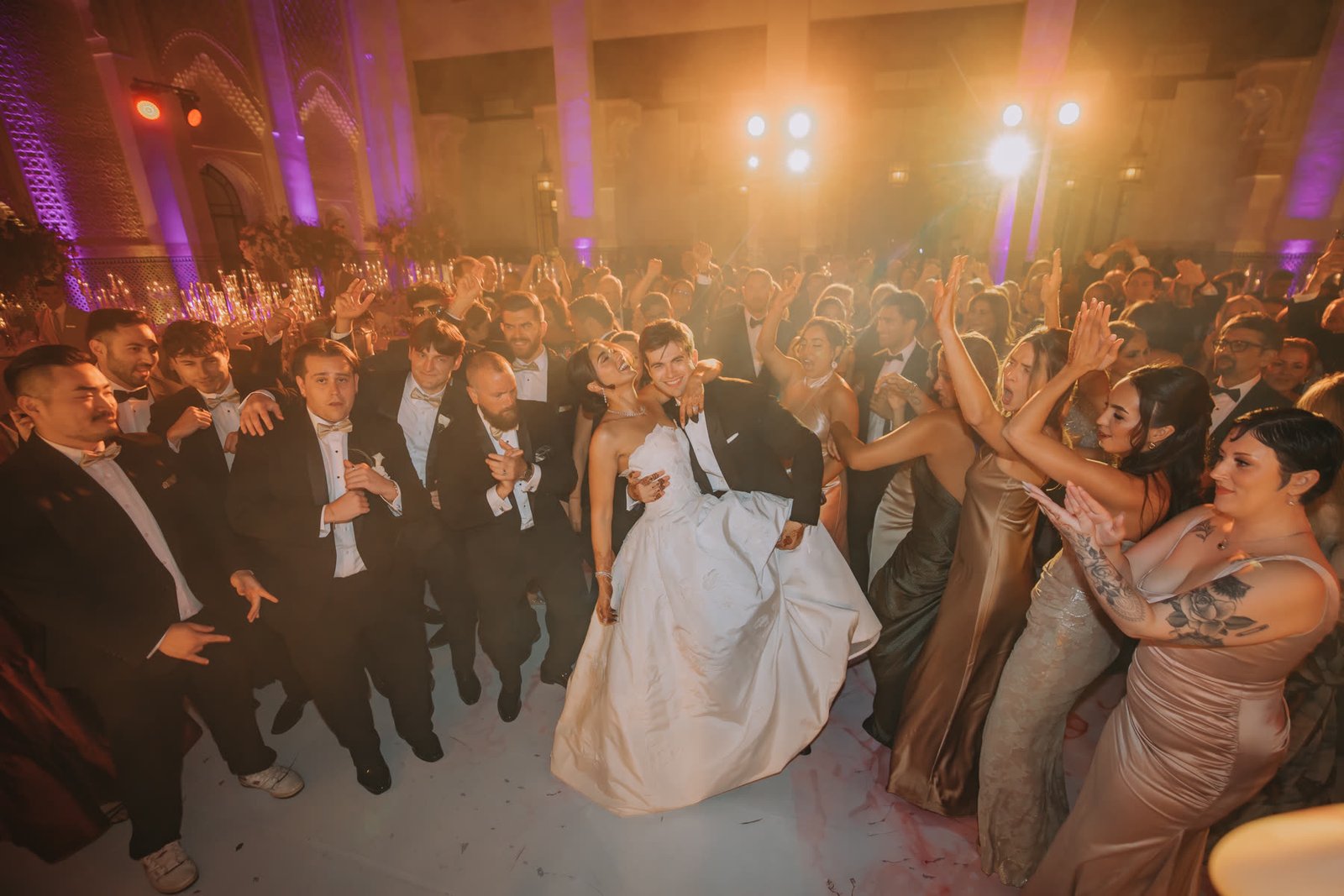 Henna and Ben surrounded by guests on the dance floor