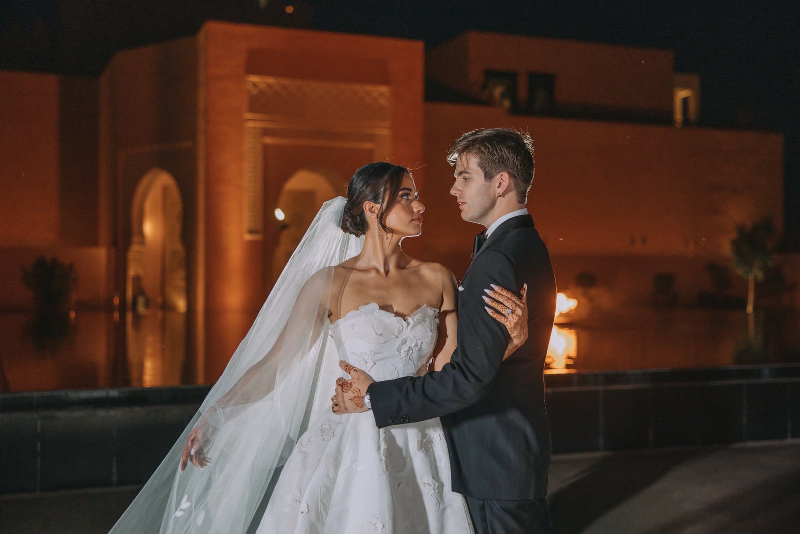 Henna and Ben at night in front of the palace walls