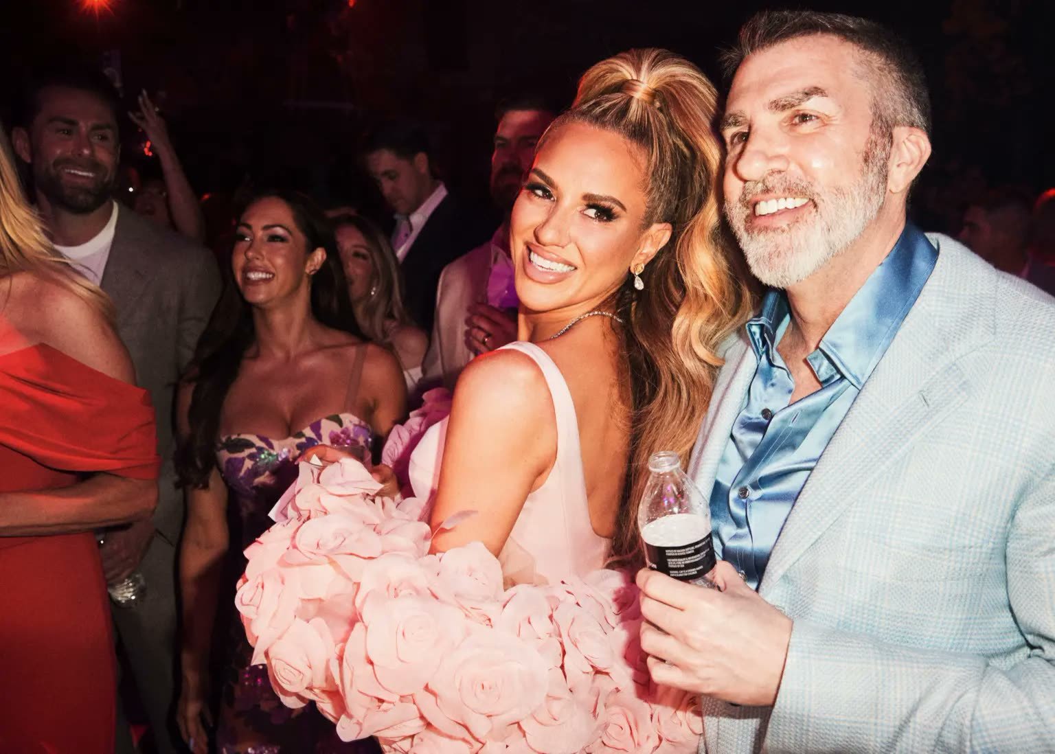 Guests dancing beneath oversized floral installations at Marcella Raneri and Daniel Nutkis's engagement party